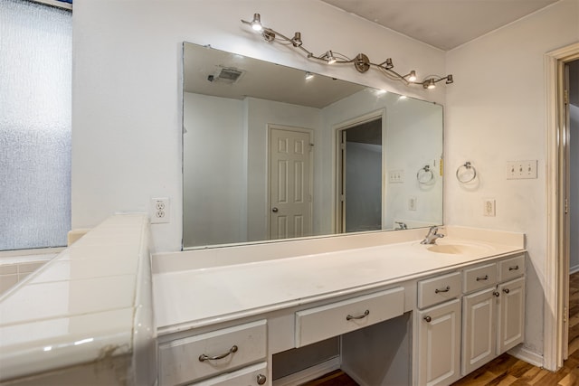 bathroom with vanity and wood-type flooring