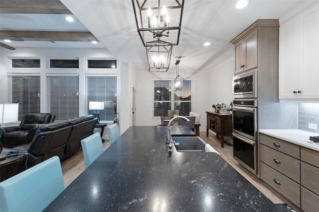 3509 Castine Ct, Bryan, TX 77808 - kitchen with stainless steel appliances, open floor plan, a chandelier, light wood-type flooring, and recessed lighting