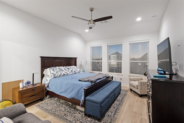 bedroom with ceiling fan, light hardwood / wood-style floors, and lofted ceiling