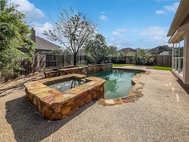 view of pool featuring an in ground hot tub and a patio area