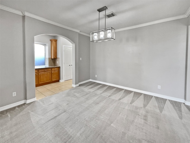 spare room with light carpet and crown molding