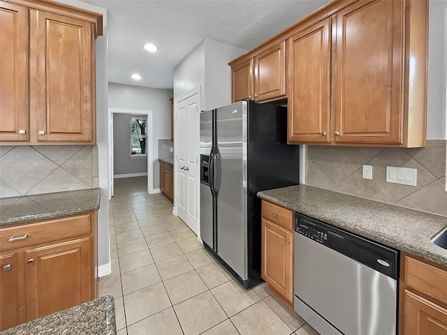 kitchen with decorative backsplash, light tile patterned flooring, and appliances with stainless steel finishes