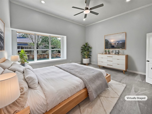 carpeted bedroom featuring ceiling fan and crown molding