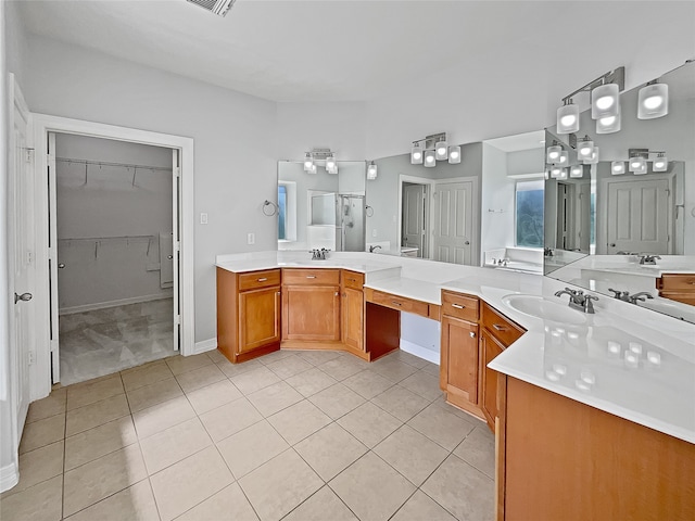 bathroom featuring vanity, tile patterned floors, and a shower with shower door