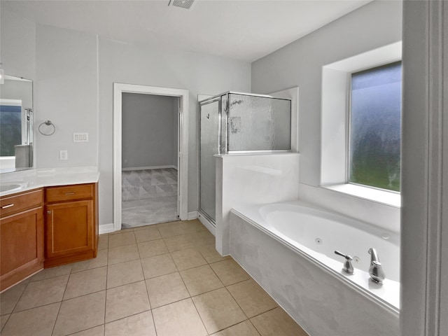 bathroom featuring tile patterned flooring, vanity, and shower with separate bathtub