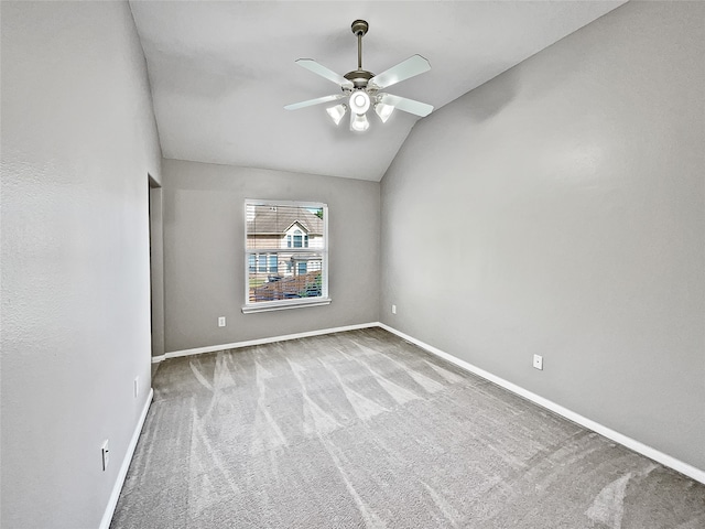 empty room with light colored carpet, vaulted ceiling, and ceiling fan