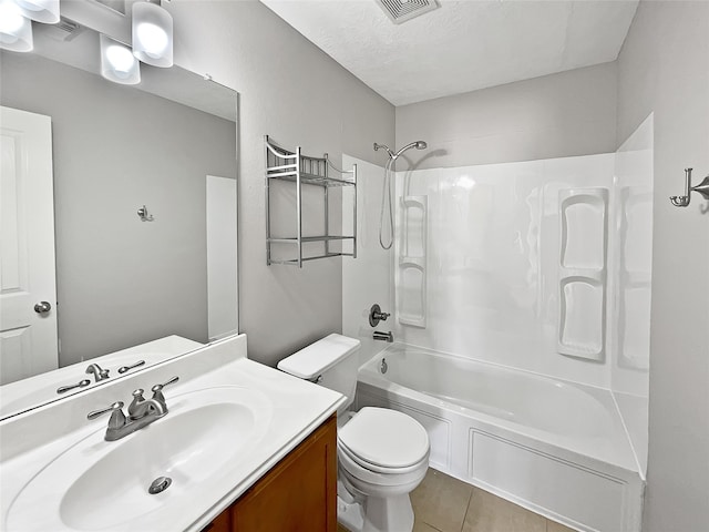 full bathroom featuring shower / bathing tub combination, vanity, tile patterned floors, toilet, and a textured ceiling