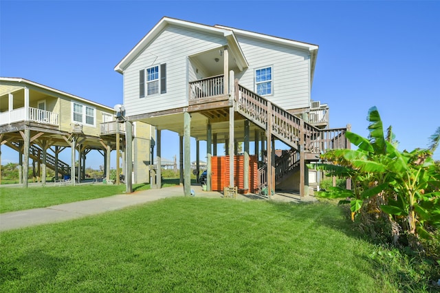 rear view of house with a yard and a carport