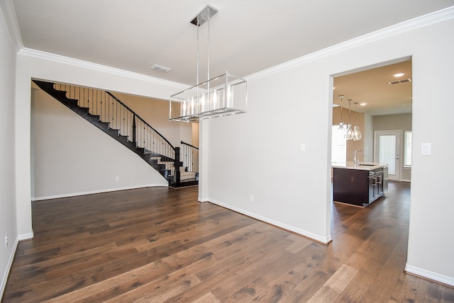 unfurnished dining area with ornamental molding, dark wood-type flooring, and sink