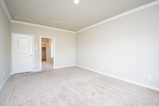 carpeted spare room featuring ornamental molding