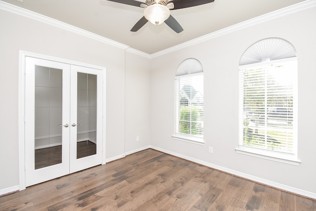 empty room with ceiling fan, french doors, dark hardwood / wood-style floors, and ornamental molding