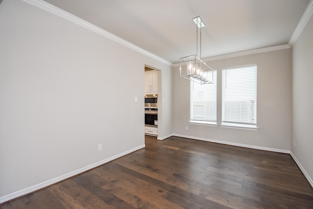 unfurnished dining area featuring dark hardwood / wood-style floors, crown molding, and a chandelier