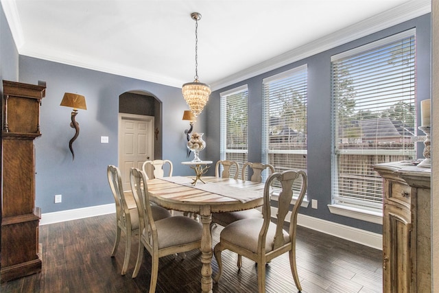 dining space featuring ornamental molding, an inviting chandelier, and dark hardwood / wood-style floors