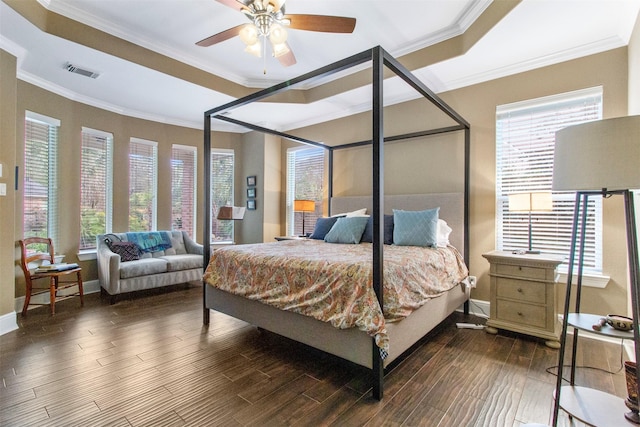 bedroom featuring ceiling fan, dark hardwood / wood-style flooring, a raised ceiling, and crown molding