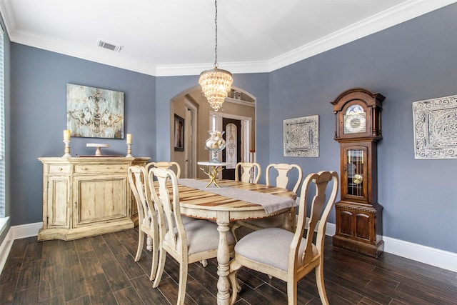 dining area featuring crown molding and a notable chandelier