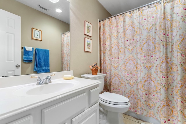 bathroom featuring vanity, tile patterned flooring, and toilet