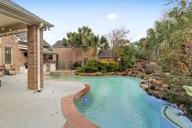 view of swimming pool with an in ground hot tub and a patio