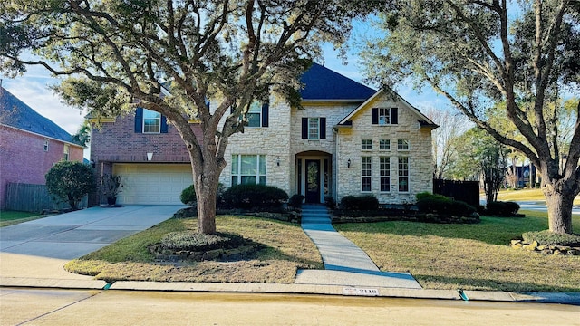 view of front of home with a front lawn and a garage