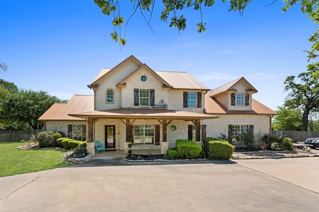 5960HIGHWAY 36 N, Bellville, TX 77418 - view of front of property featuring covered porch, stone siding, metal roof, and fence