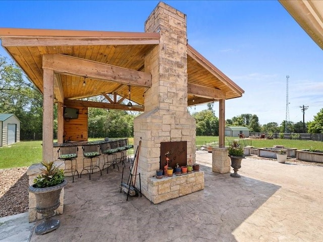 5960HIGHWAY 36 N, Bellville, TX 77418 - view of patio / terrace featuring fence, an outdoor stone fireplace, outdoor dry bar, and a gazebo