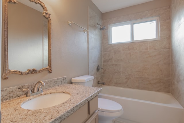 full bathroom with tiled shower / bath combo, toilet, and vanity