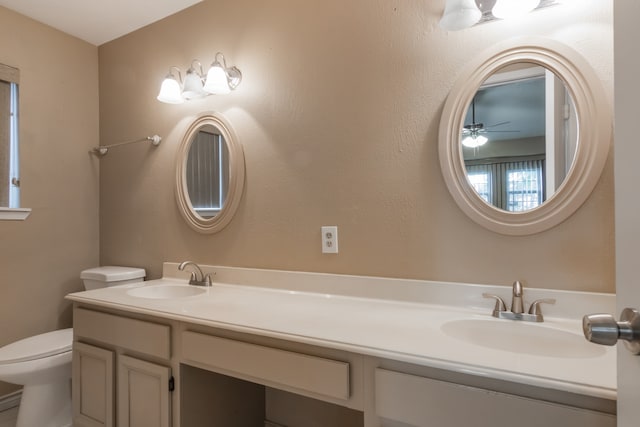 bathroom featuring vanity, ceiling fan, and toilet