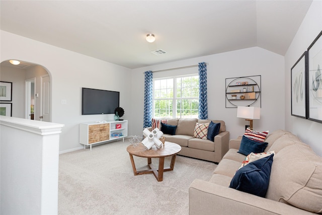 living room featuring vaulted ceiling and light carpet