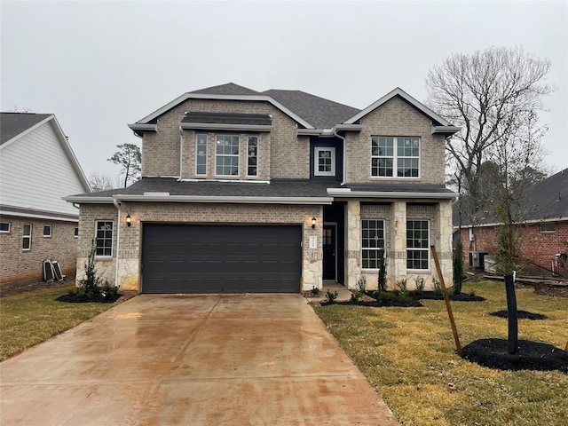 view of front facade with a garage and a front lawn