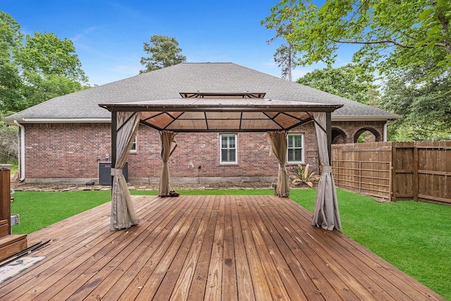 wooden deck featuring a gazebo and a lawn