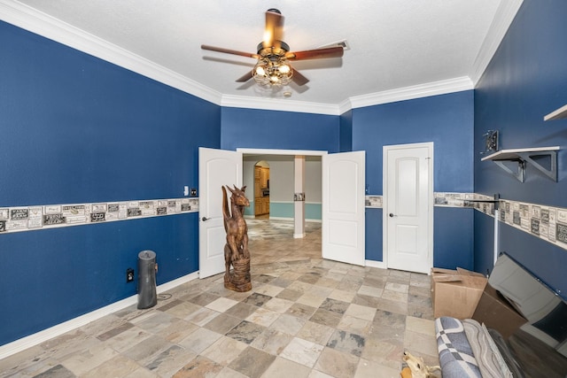 laundry area with ceiling fan, ornamental molding, and a textured ceiling