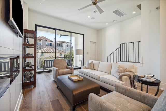 living room with ceiling fan and dark wood-type flooring