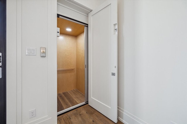 interior space with elevator and hardwood / wood-style flooring