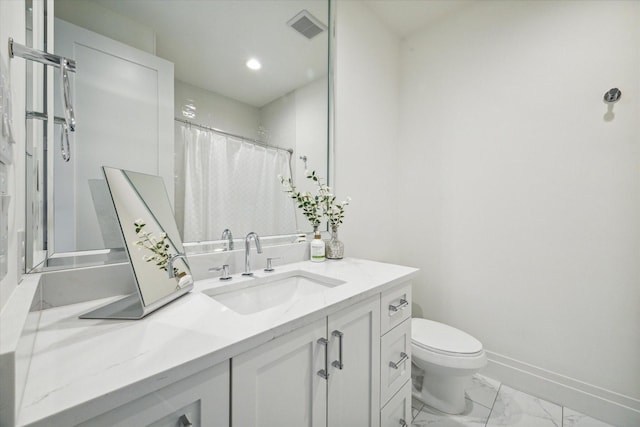 bathroom with vanity, toilet, and walk in shower