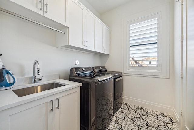 washroom with washer and clothes dryer, sink, and cabinets