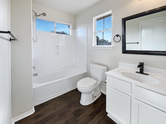 full bathroom with washtub / shower combination, wood-type flooring, vanity, and toilet