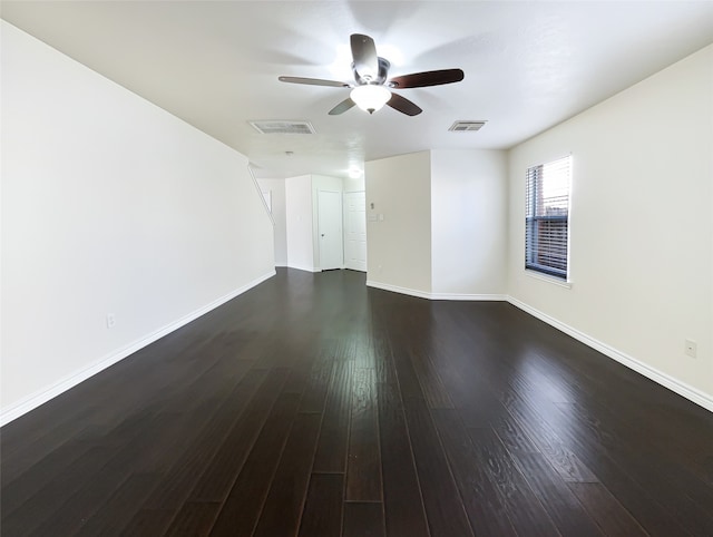 empty room featuring dark hardwood / wood-style flooring and ceiling fan