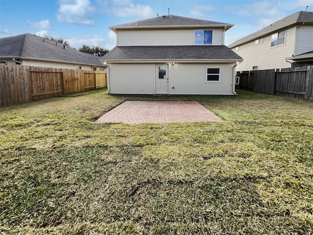 rear view of house featuring a patio area and a yard