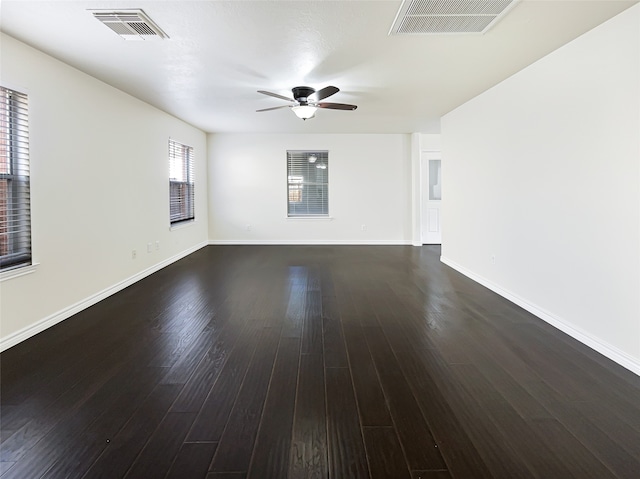 empty room with dark hardwood / wood-style floors and ceiling fan