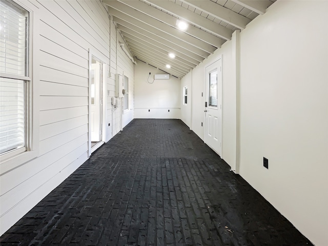 hall with beam ceiling, wooden walls, high vaulted ceiling, and an AC wall unit