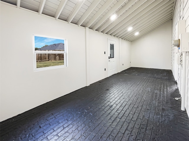 spare room with vaulted ceiling with beams