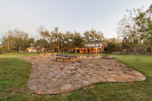 exterior space featuring a lawn and a patio area