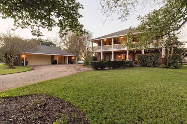 view of front of property with a balcony and a front lawn