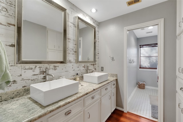 bathroom with hardwood / wood-style floors and vanity