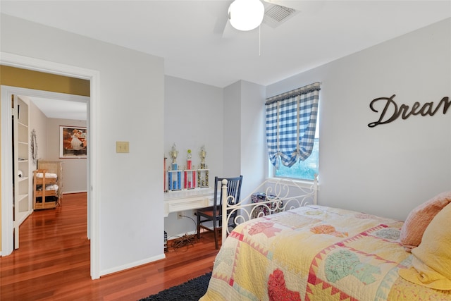 bedroom with ceiling fan and wood-type flooring