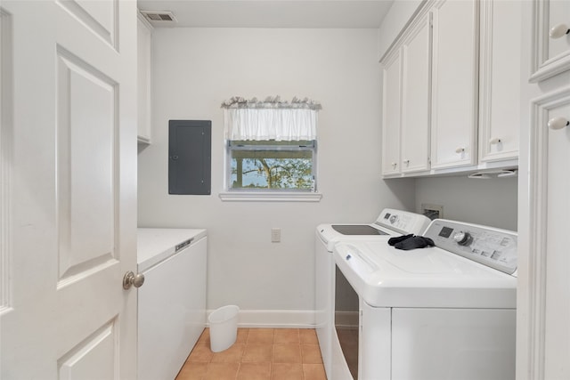 laundry area with electric panel, light tile patterned flooring, cabinets, and independent washer and dryer