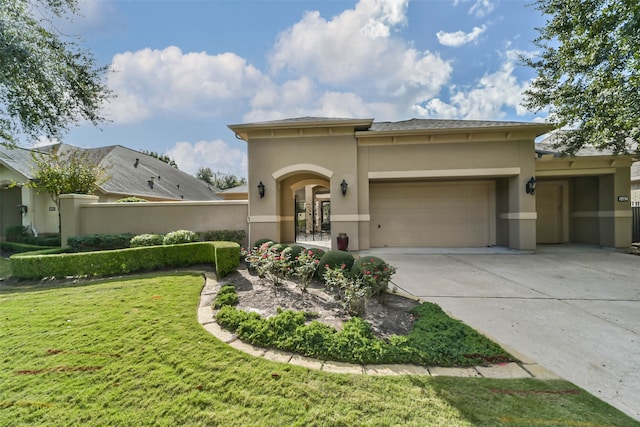 view of front of house with a garage and a front lawn