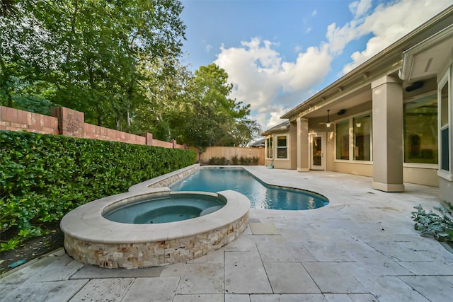 view of swimming pool featuring an in ground hot tub and a patio