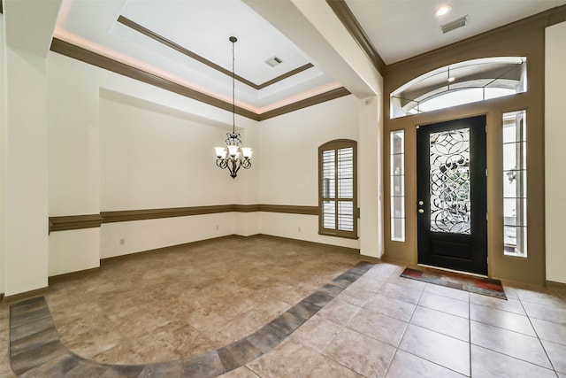 foyer featuring light tile patterned floors, crown molding, and a chandelier