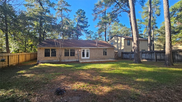 rear view of house with a yard and a patio