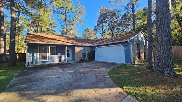 single story home featuring a porch and a garage